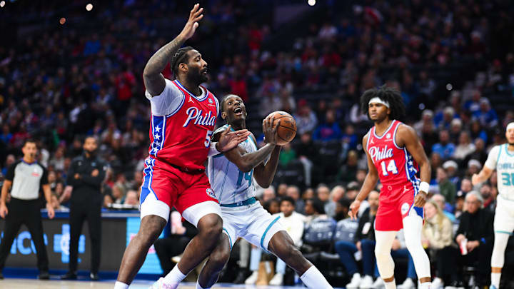 Dec 20, 2024; Philadelphia, Pennsylvania, USA; Charlotte Hornets forward Moussa Diabate (14) drives against Philadelphia 76ers center Andre Drummond (5) in the first quarter at Wells Fargo Center. Mandatory Credit: Kyle Ross-Imagn Images