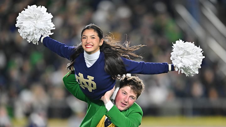 Nov 9, 2024; South Bend, Indiana, USA; The Notre Dame Fighting Irish Leprechaun mascot carries a cheerleader in the second quarter of a game between the Notre Dame Fighting Irish and the Florida State Seminoles at Notre Dame Stadium. Mandatory Credit: Matt Cashore-Imagn Images