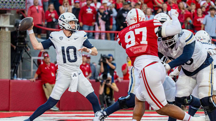 Nebraska defensive lineman Keona Davis pressures Akron quarterback Ben Finley.