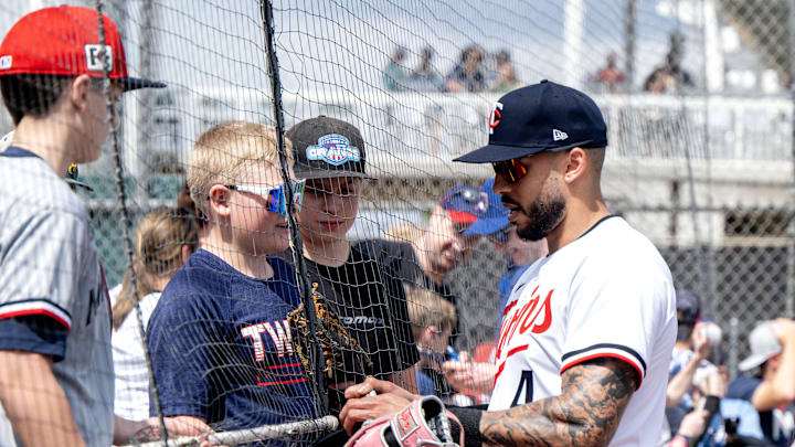 Minnesota Twins shortstop Carlos Correa (4) takes a moment to sign autographs for young fans before their game with the Atlanta Braves at Lee Health Sports Complex in 2025.