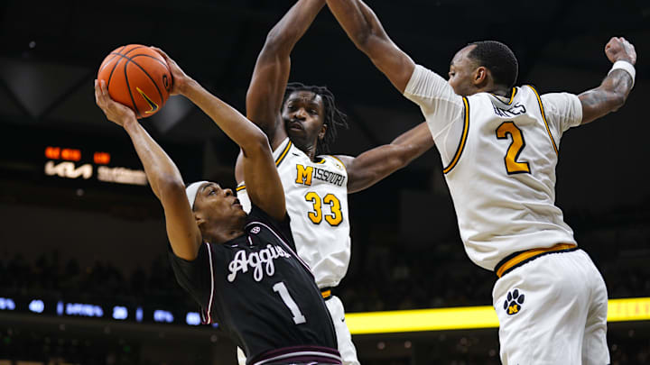 Feb 8, 2025; Columbia, Missouri, USA; Texas A&M Aggies guard Zhuric Phelps (1) shoots against Missouri Tigers center Josh Gray (33) and guard Tamar Bates (2) during the second half at Mizzou Arena. Mandatory Credit: Jay Biggerstaff-Imagn Images Feb 8, 2025; Columbia, Missouri, USA; Texas A&M Aggies guard Zhuric Phelps (1) shoots against Missouri Tigers center Josh Gray (33) and guard Tamar Bates (2) during the second half at Mizzou Arena. Mandatory Credit: Jay Biggerstaff-Imagn Images