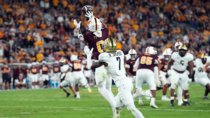 Nov 9, 2024; Tempe, Arizona, USA; Arizona State Sun Devils wide receiver Jordyn Tyson (0) catches a touchdown pass against UCF Knights defensive back Antione Jackson (7) during the second half at Mountain America Stadium, Home of the ASU Sun Devils. Mandatory Credit: Joe Camporeale-Imagn Images