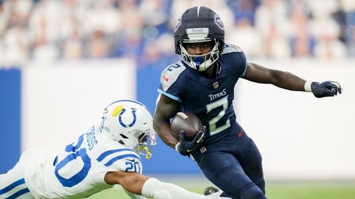 Indianapolis Colts safety Nick Cross (20) dives after Tennessee Titans running back Tyjae Spears (2) on Sunday, Dec. 22, 2024, during a game against the Tennessee Titans at Lucas Oil Stadium in Indianapolis.