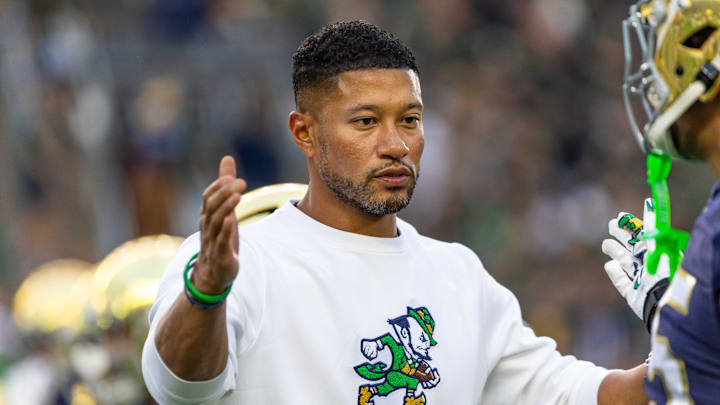 Sep 13, 2025; South Bend, Indiana, USA; Notre Dame Fighting Irish head coach Marcus Freeman greets players before a game against the Texas A&M Aggies at Notre Dame Stadium. Mandatory Credit: Michael Caterina-Imagn Images