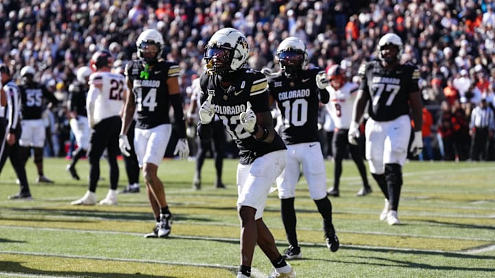 Nov 29, 2024; Boulder, Colorado, USA; Colorado Buffaloes wide receiver Travis Hunter (12) dances following his third quarter touchdown reception against the Oklahoma State Cowboys at Folsom Field. Mandatory Credit: Ron Chenoy-Imagn Images
