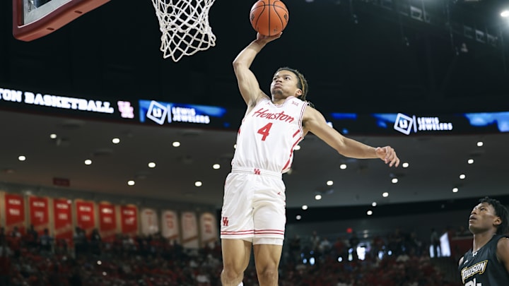 Nov 8, 2025; Houston, Texas, USA; Houston Cougars guard Kingston Flemings (4) dunks the ball during the first half against the Towson Tigers at Fertitta Center. Mandatory Credit: Troy Taormina-Imagn Images
