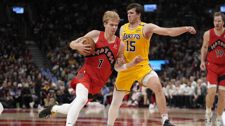 Nov 1, 2024; Toronto, Ontario, CAN; Toronto Raptors guard Gradey Dick (1) drives to the net against Los Angeles Lakers guard Austin Reaves (15) during the second half at Scotiabank Arena. Mandatory Credit: John E. Sokolowski-Imagn Images