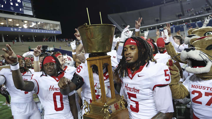 Sep 6, 2025; Houston, Texas, USA; Houston Cougars wide receiver Stephon Johnson (5) holds the Bayou Bucket trophy after the game against the Rice Owls at Rice Stadium. Mandatory Credit: Troy Taormina-Imagn Images