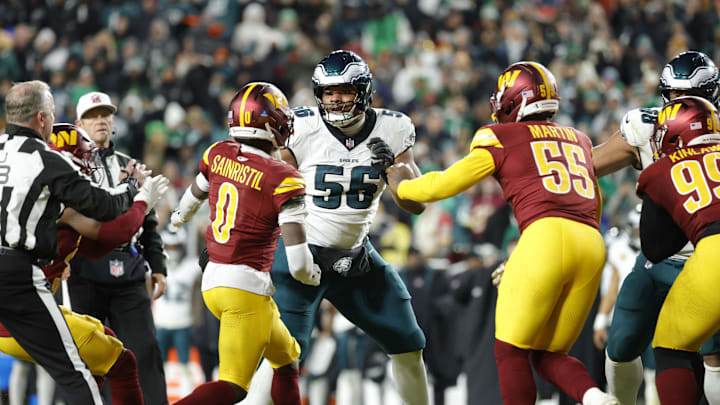 Dec 20, 2025; Landover, Maryland, USA; Philadelphia Eagles guard Tyler Steen (56) exchanges words with Washington Commanders cornerback Mike Sainristil (0), Commanders defensive end Jacob Martin (55) and Commanders safety Jeremy Reaves (39) during the second half at Northwest Stadium. Mandatory Credit: Amber Searls-Imagn Images