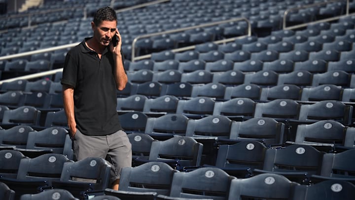 Oct 17, 2022; San Diego, CA, USA; San Diego Padres general manager AJ Preller speaks on the phone during NLCS workouts at Petco Park. Mandatory Credit: Orlando Ramirez-Imagn Images
