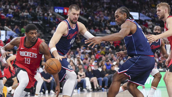 Apr 9, 2025; Inglewood, California, USA; Houston Rockets guard Nate Williams (19) fights to keep possession against Los Angeles Clippers center Ivica Zubac (40) and forward Kawhi Leonard (2) in the second half at Intuit Dome. Mandatory Credit: Kirby Lee-Imagn Images