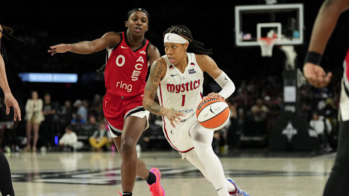 Jun 26, 2025; Las Vegas, Nevada, USA; Washington Mystics guard Sug Sutton (1) drives the ball past Las Vegas Aces guard Jackie Young (0) during the second half of a WNBA basketball game at Michelob Ultra Arena. 