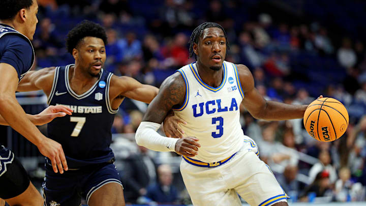 Mar 20, 2025; Lexington, KY, USA;  UCLA Bruins guard Eric Dailey Jr. (3) drives to the basket against Utah State Aggies guard Dexter Akanno (7) during the second half in the first round of the NCAA Tournament at Rupp Arena.