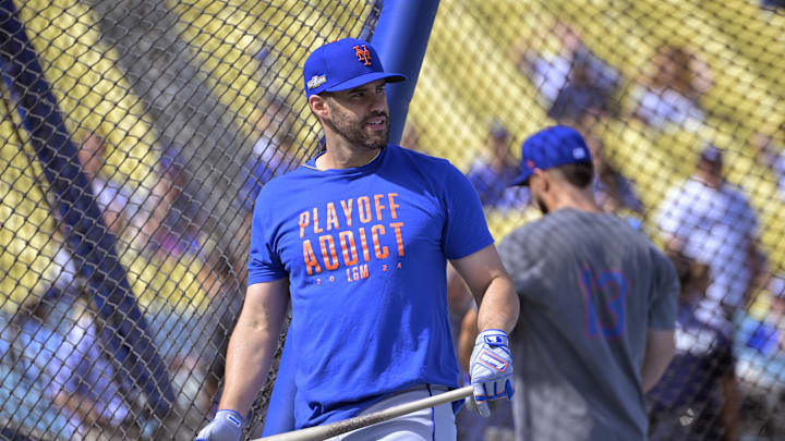 New York Mets designated hitter J.D. Martinez (28) warms up in batting cages