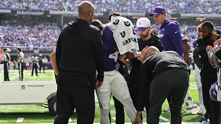 Aug 9, 2025; Minneapolis, Minnesota, USA; Minnesota Vikings wide receiver Rondale Moore (4) is attended to by head coach Kevin O'Connell and trainers after suffering a lower leg injury during the second quarter against the Houston Texans at U.S. Bank Stadium. Mandatory Credit: Jeffrey Becker-Imagn Images