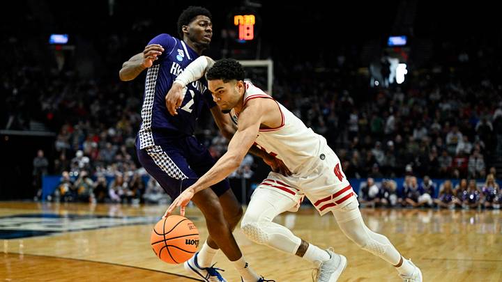 Mar 19, 2026; Portland, OR, USA; Wisconsin Badgers guard Nick Boyd (2) drives against High Point Panthers guard Scotty Washington (12) during the second half of a first round game of the men's 2026 NCAA Tournament at Moda Center. Mandatory Credit: Troy Wayrynen-Imagn Images