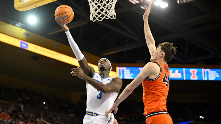 Eric Dailey Jr. drives to the basket as Zvonimir Ivisic moves in to defend during the first half at Pauley Pavilion.