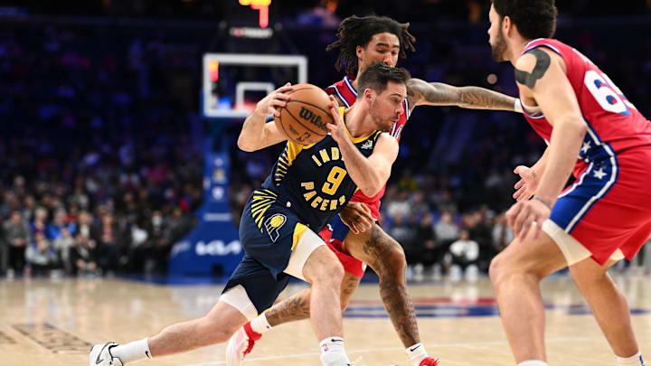 Mar 14, 2025; Philadelphia, Pennsylvania, USA; Indiana Pacers guard T.J. McConnell (9) drives against Philadelphia 76ers guard Jalen-Hood Schifino (17) in the fourth quarter at Wells Fargo Center. Mandatory Credit: Kyle Ross-Imagn Images