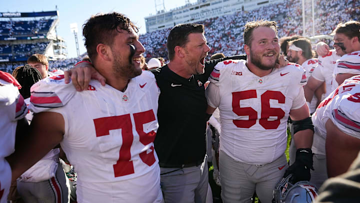 Ohio State Buckeyes offensive line coach Justin Frye celebrates with offensive linemen Carson Hinzman (75) and Seth McLaughlin (56) following the 20-13 win over the Penn State Nittany Lions in NCAA football game at Beaver Stadium in University Park, Pa. on Saturday, Nov. 2, 2024.