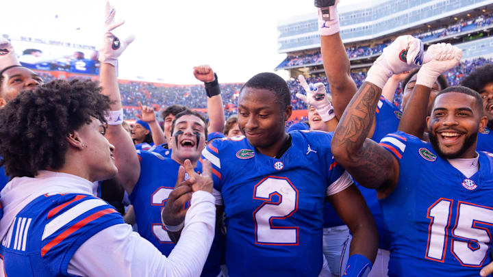 Florida Gators quarterback DJ Lagway (2) celebrates at Ben Hill Griffin Stadium with teammates Florida Gators wide receiver Eugene Wilson III (3) and Florida Gators linebacker Derek Wingo (15) in Gainesville, FL on Saturday, November 23, 2024. The Gators defeated the Rebels 24-17 [Doug Engle/Gainesville Sun]