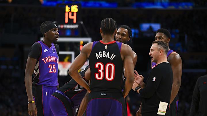 Nov 10, 2024; Los Angeles, California, USA; Toronto Raptors head coach Darko Rajakovic meets with guard Ochai Agbaji (30), forward Chris Boucher (25), and other players during a timeout against the Los Angeles Lakers during the second half at Crypto.com Arena. Mandatory Credit: Jonathan Hui-Imagn Images