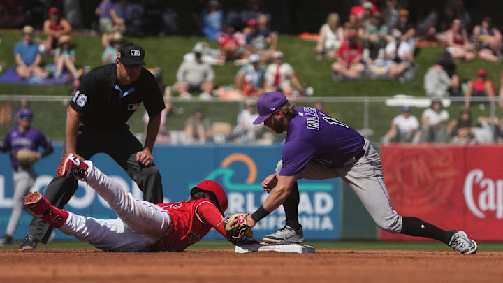 Angels baserunner JD Davis hits a double against the Colorado Rockies in the second inning at Tempe Diablo Stadium.