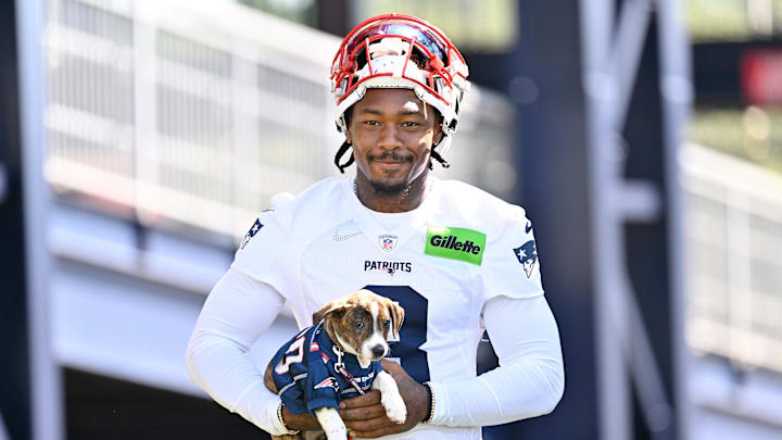 Jul 23, 2025; Foxborough, MA, USA; New England Patriots wide receiver Stefon Diggs (8) delivers a puppy to a local family as part of the Patriots pet adoption event before training camp at Gillette Stadium. Mandatory Credit: Eric Canha-Imagn Images