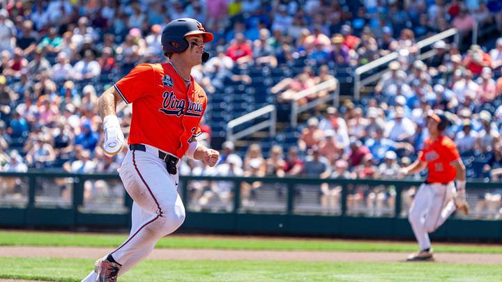 Jun 14, 2024; Omaha, NE, USA; Virginia Cavaliers second baseman Henry Godbout (2) runs to third on a double by third baseman Eric Becker (21) during the fourth inning at Charles Schwab Filed Omaha. Mandatory Credit: Dylan Widger-Imagn Images