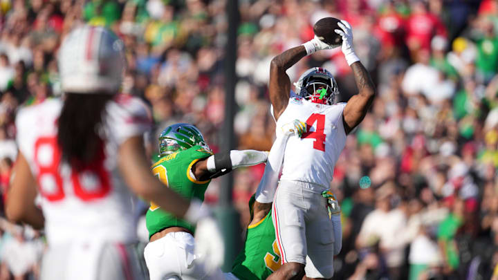 Jan 1, 2025; Pasadena, CA, USA; Ohio State Buckeyes wide receiver Jeremiah Smith (4) makes a catch in the first quarter against the Oregon Ducks in the 2025 Rose Bowl college football quarterfinal game at Rose Bowl Stadium. Mandatory Credit: Kirby Lee-Imagn Images