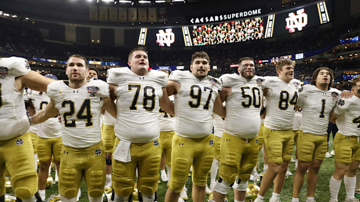 Notre Dame Fighting Irish players celebrate with fans in the stands after defeating the Georgia Bulldogs at Caesars Superdome on January 2, 2025. 