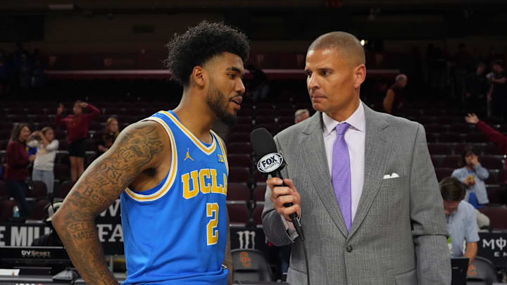 Mar 7, 2026; Los Angeles, California, USA; FS1 analyst Miles Simon (right) interviews UCLA Bruins guard Donovan Dent (2) after the game against the Southern California Trojans at the Galen Center. Mandatory Credit: Kirby Lee-Imagn Images