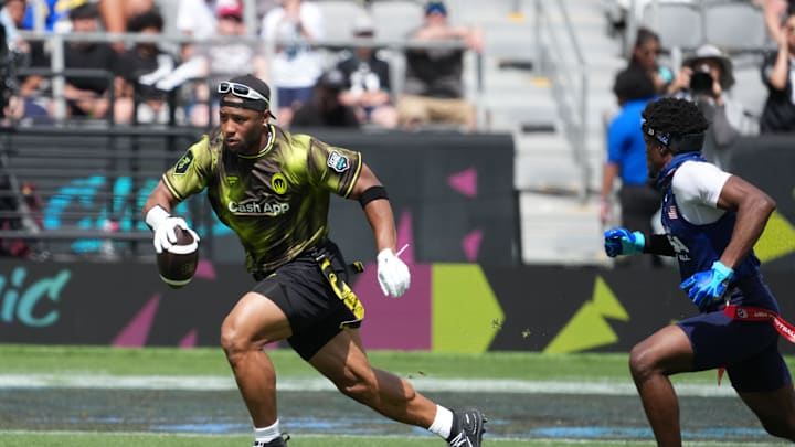 Mar 21, 2026; Los Angeles, CA, USA; Wildcats FFC running back Saquon Barkley carries the ball against Team USA defensive back Jamie Kennedy during the Fanatics Flag Football Classic at BMO stadium. Mar 21, 2026; Los Angeles, CA, USA; Wildcats FFC running back Saquon Barkley carries the ball against Team USA defensive back Jamie Kennedy during the Fanatics Flag Football Classic at BMO stadium.