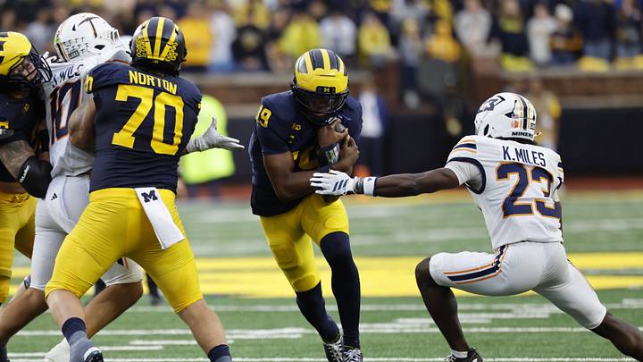 Sep 19, 2026; Ann Arbor, Michigan, USA;  Michigan Wolverines quarterback Bryce Underwood (19) is defended by Texas El Paso Miners cornerback Kaleb Miles (23) during the third quarter at Michigan Stadium.  Mandatory Credit: Rick Osentoski-Imagn Images
