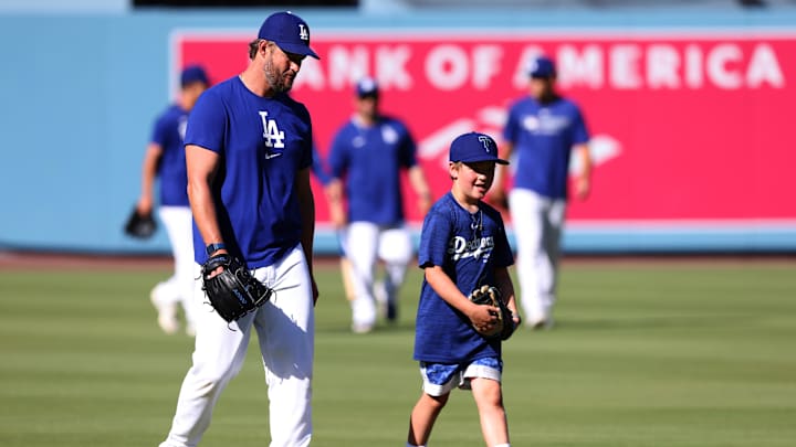 May 30, 2025; Los Angeles, California, USA; Los Angeles Dodgers pitcher Clayton Kershaw (22) and his son Charley Kershaw before a game against the New York Yankees at Dodger Stadium. Mandatory Credit: Jason Parkhurst-Imagn Images