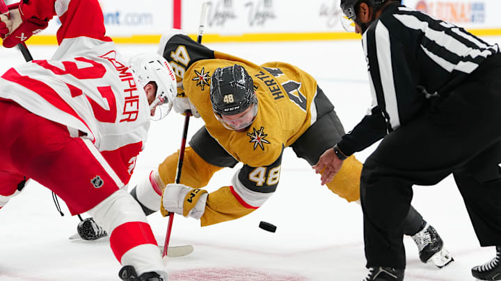 Mar 22, 2025; Las Vegas, Nevada, USA; Vegas Golden Knights center Tomas Hertl (48) takes a face-off against Detroit Red Wings left wing J.T. Compher (37) during the first period at T-Mobile Arena. Mandatory Credit: Stephen R. Sylvanie-Imagn Images