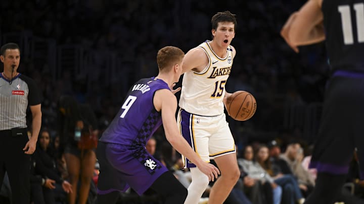 Oct 26, 2024; Los Angeles, California, USA; Los Angeles Lakers guard Austin Reaves (15) looks to pass against Sacramento Kings guard Kevin Huerter (9) during the second half at Crypto.com Arena. Mandatory Credit: Jonathan Hui-Imagn Images