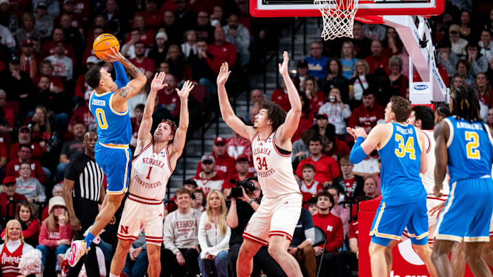 Jan 4, 2025; Lincoln, Nebraska, USA; UCLA Bruins guard Kobe Johnson (0) shoots the ball against Nebraska Cornhuskers guard Sam Hoiberg (1) and center Braxton Meah (34) during the first half at Pinnacle Bank Arena. Mandatory Credit: Dylan Widger-Imagn Images Jan 4, 2025; Lincoln, Nebraska, USA; UCLA Bruins guard Kobe Johnson (0) shoots the ball against Nebraska Cornhuskers guard Sam Hoiberg (1) and center Braxton Meah (34) during the first half at Pinnacle Bank Arena. Mandatory Credit: Dylan Widger-Imagn Images