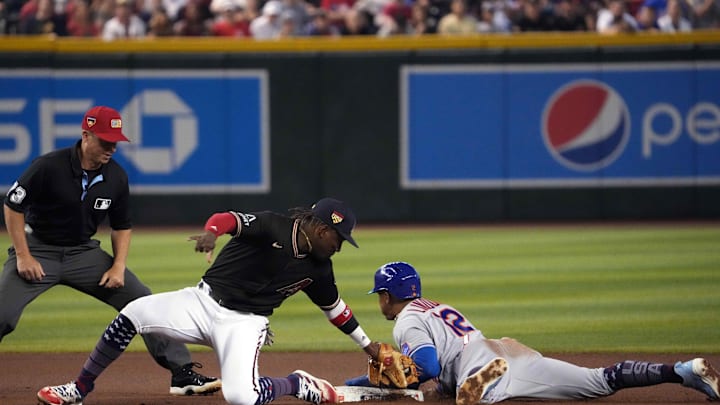 Jul 4, 2023; Phoenix, Arizona, USA; New York Mets shortstop Francisco Lindor (12) beats the tag of Arizona Diamondbacks second baseman Geraldo Perdomo (2) to steal second base during the fourth inning at Chase Field. Mandatory Credit: Joe Camporeale-Imagn Images