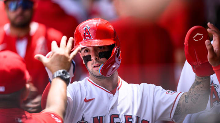 May 3, 2026; Anaheim, California, USA; Los Angeles Angels shortstop Zach Neto (9) is greeted by teammates after scoring during the first inning against the New York Mets at Angel Stadium. Mandatory Credit: William Liang-Imagn Images