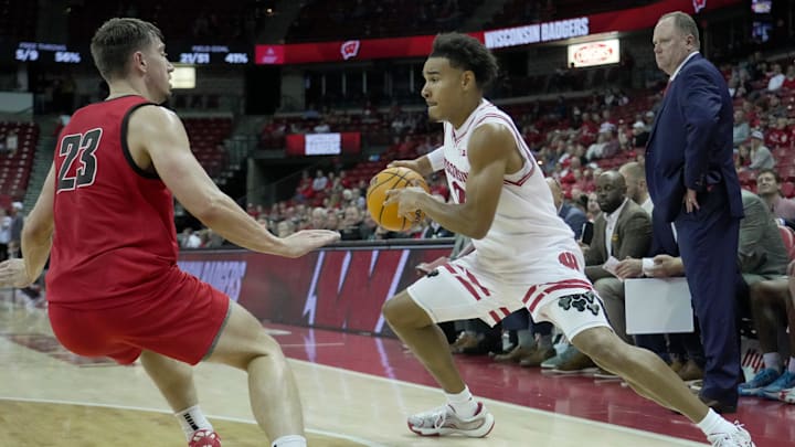 Wisconsin guard John Tonje (9) makes a move on UW-River Falls guard Zac Johnson (23) during the second half of their preseason game Wednesday, October 30, 2024 at the Kohl Center in Madison, Wisconsin. Wisconsin beat UW-River Falls 78-62.