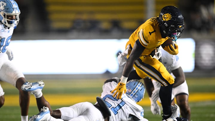 Oct 17, 2025; Berkeley, California, USA; California Golden Bears running back Kendrick Raphael (1) gets tripped up by North Carolina Tar Heels defensive back Kaleb Cost (21) in the third quarter at California Memorial Stadium. Oct 17, 2025; Berkeley, California, USA; California Golden Bears running back Kendrick Raphael (1) gets tripped up by North Carolina Tar Heels defensive back Kaleb Cost (21) in the third quarter at California Memorial Stadium.