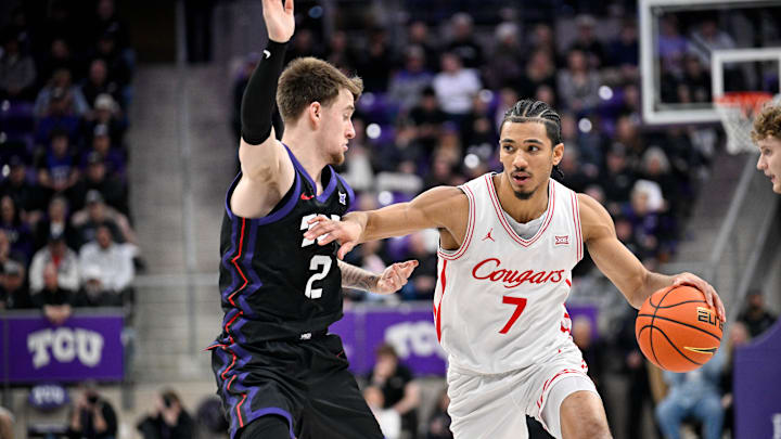 Jan 28, 2026; Fort Worth, Texas, USA; Houston Cougars guard Milos Uzan (7) brings the ball up court past TCU Horned Frogs guard Brock Harding (2) during the second half at Ed and Rae Schollmaier Arena. Mandatory Credit: Jerome Miron-Imagn Images