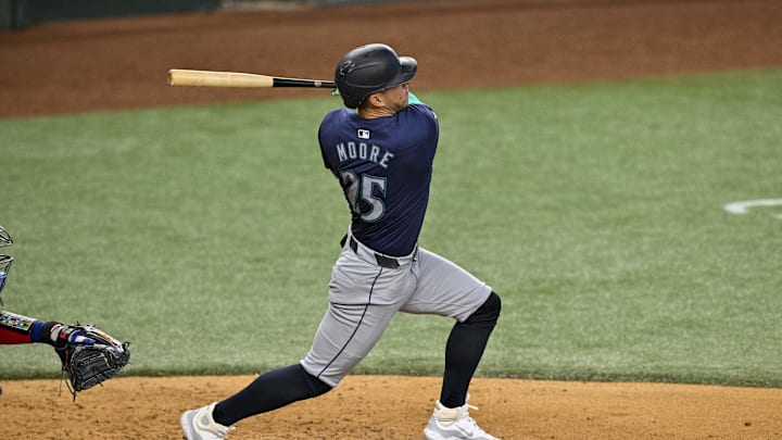 Seattle Mariners third baseman Dylan Moore (25) hits a double against the Texas Rangers during the sixth inning at Globe Life Field in 2024.