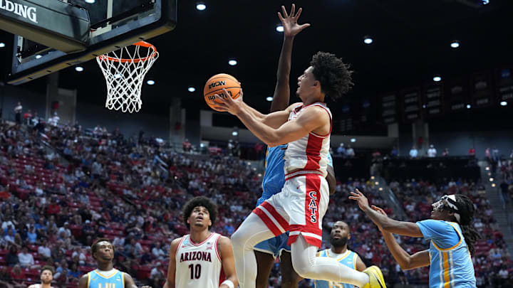 Mar 20, 2026; San Diego, CA, USA; Arizona Wildcats guard Brayden Burries (5) shoots against LIU Sharks forward Jamal Fuller (33) in the first half during a first round game of the men's 2026 NCAA Tournament at Viejas Arena. Mandatory Credit: Kirby Lee-Imagn Images Mar 20, 2026; San Diego, CA, USA; Arizona Wildcats guard Brayden Burries (5) shoots against LIU Sharks forward Jamal Fuller (33) in the first half during a first round game of the men's 2026 NCAA Tournament at Viejas Arena. Mandatory Credit: Kirby Lee-Imagn Images