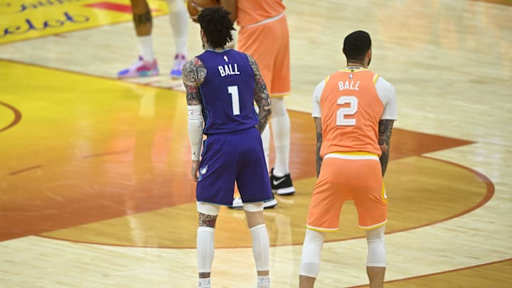 Dec 22, 2025; Cleveland, Ohio, USA; Charlotte Hornets guard Lamelo Ball (1) and Cleveland Cavaliers guard Lonzo Ball (2) stand on the court in the fourth quarter at Rocket Arena. Mandatory Credit: David Richard-Imagn Images