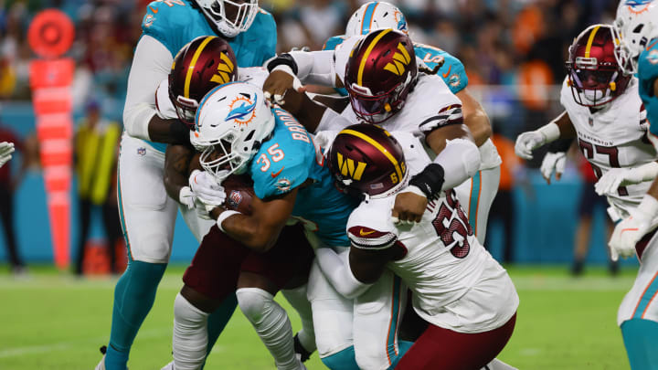Aug 17, 2024; Miami Gardens, Florida, USA; Miami Dolphins running back Chris Brooks (35) runs with the football against Washington Commanders defensive end Jalen Harris (56) during the second quarter of a preseason game at Hard Rock Stadium. Mandatory Credit: Sam Navarro-USA TODAY Sports Aug 17, 2024; Miami Gardens, Florida, USA; Miami Dolphins running back Chris Brooks (35) runs with the football against Washington Commanders defensive end Jalen Harris (56) during the second quarter of a preseason game at Hard Rock Stadium. Mandatory Credit: Sam Navarro-USA TODAY Sports