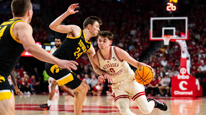 Mar 9, 2025; Lincoln, Nebraska, USA; Nebraska Cornhuskers guard Connor Essegian (0) drives against Iowa Hawkeyes forward Pryce Sandfort (24) during the first half at Pinnacle Bank Arena. Mandatory Credit: Dylan Widger-Imagn Images