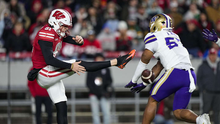 Nov 8, 2025; Madison, Wisconsin, USA;  Washington Huskies linebacker Anthony Ward (57) blocks the punt from Wisconsin Badgers kicker Sean West (91) during the second quarter at Camp Randall Stadium. Mandatory Credit: Jeff Hanisch-Imagn Images