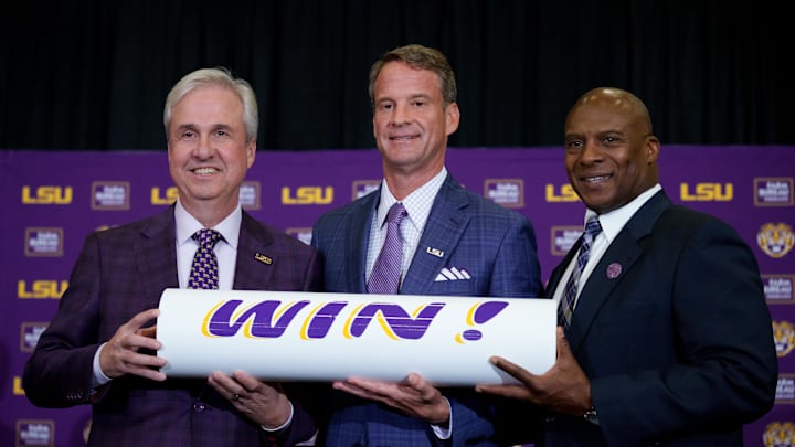 Dec 1, 2025; Baton Rouge, LA, USA; LSU president Wade Rousse, left, LSU new head coach Lane Kiffin and LSU athletic director Verge Ausberry stand together at South Stadium Club at Tiger Stadium. Mandatory Credit: Matthew Hinton-Imagn Images