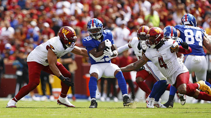 Sep 7, 2025; Landover, Maryland, USA; New York Giants running back Tyrone Tracy Jr. (29) runs the ball against Washington Commanders linebacker Bobby Wagner (54) during the second quarter at Northwest Stadium. 